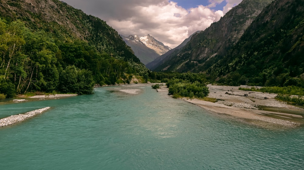 a river with mountains and trees