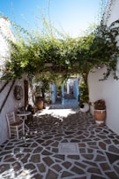 a courtyard with a table and chairs