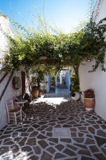 a courtyard with a table and chairs