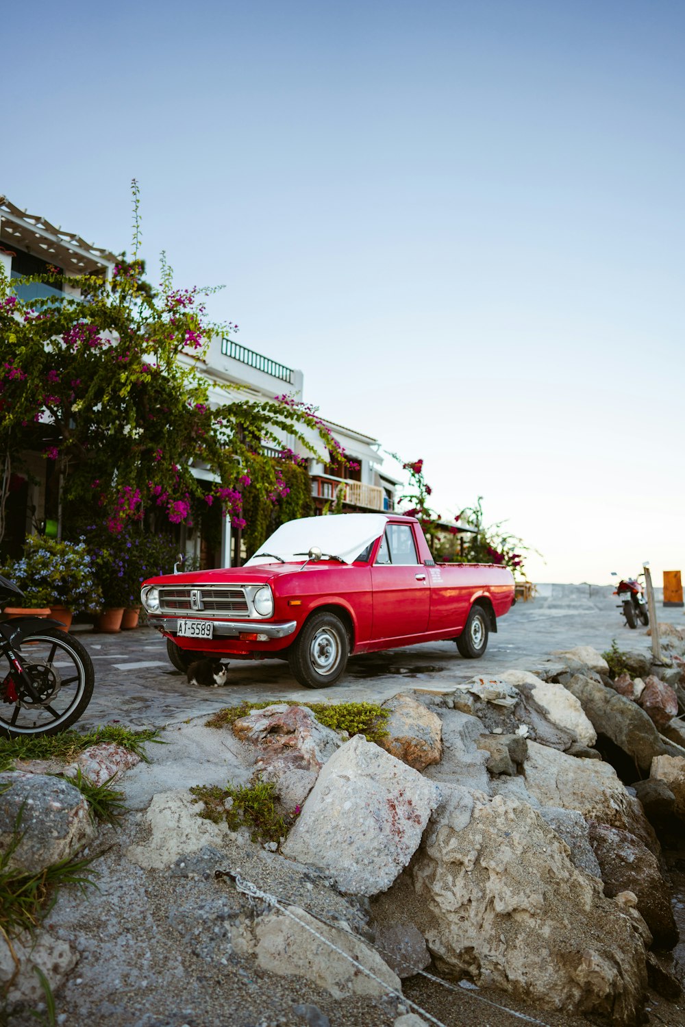 a red car parked on rocks