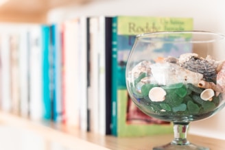 Custom resin bookmarks with delicate embedded seashells and a translucent aqua background.