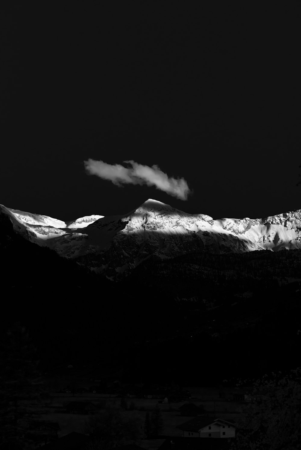 a mountain with a cloud in the sky