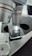 Close-up of a scientist examining a microscope slide in a bright laboratory.