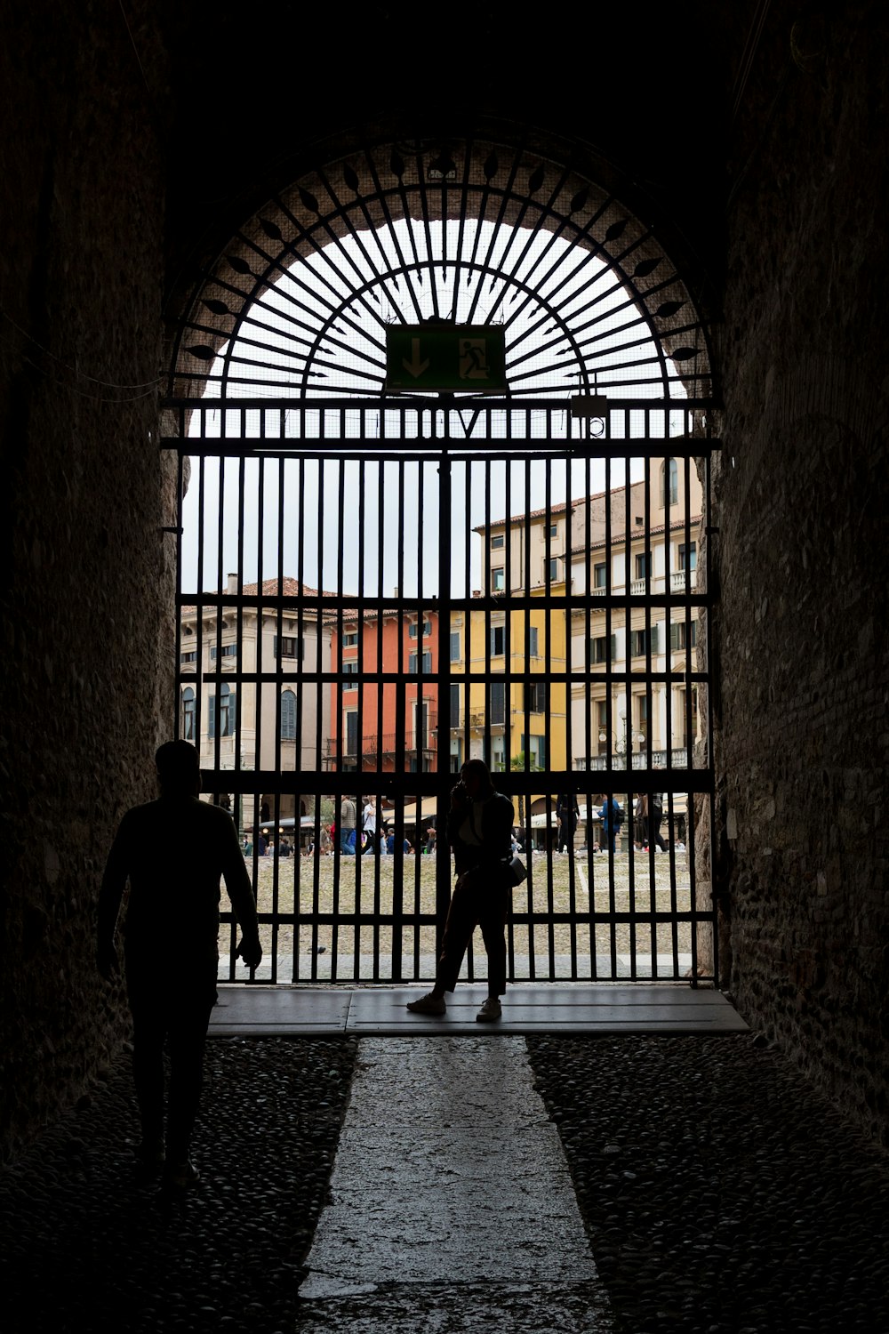 a couple of people walk through a large building