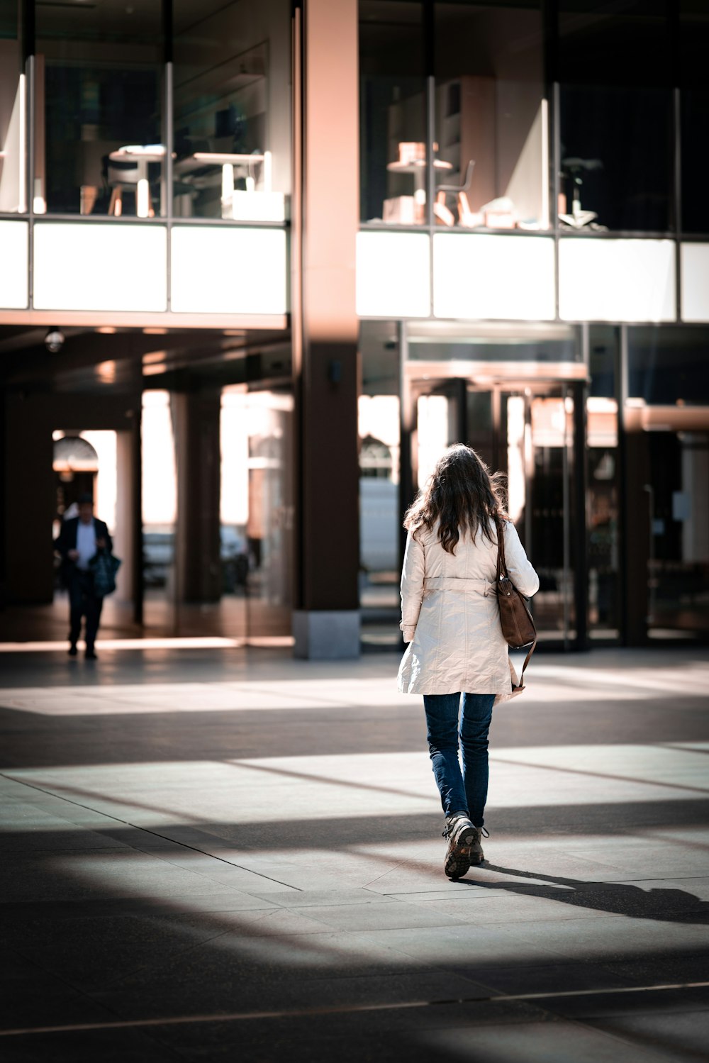 a woman walking on a sidewalk