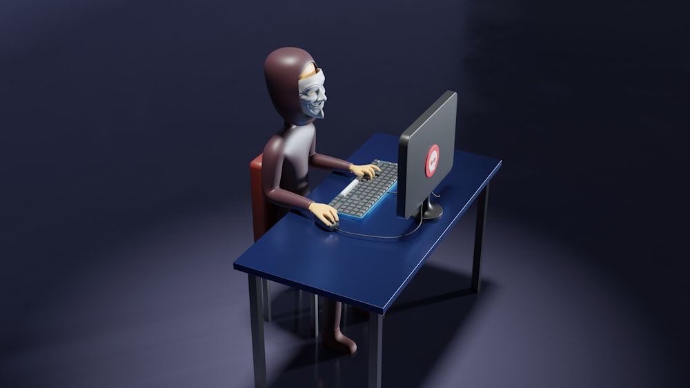 a skeleton sitting at a desk with a laptop and keyboard