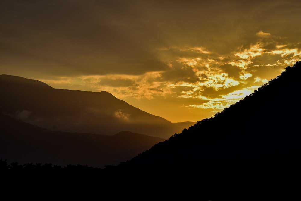 a landscape with hills and clouds