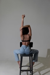 a person sitting on a stool