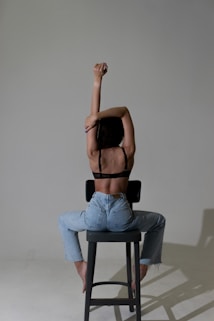 a person sitting on a stool