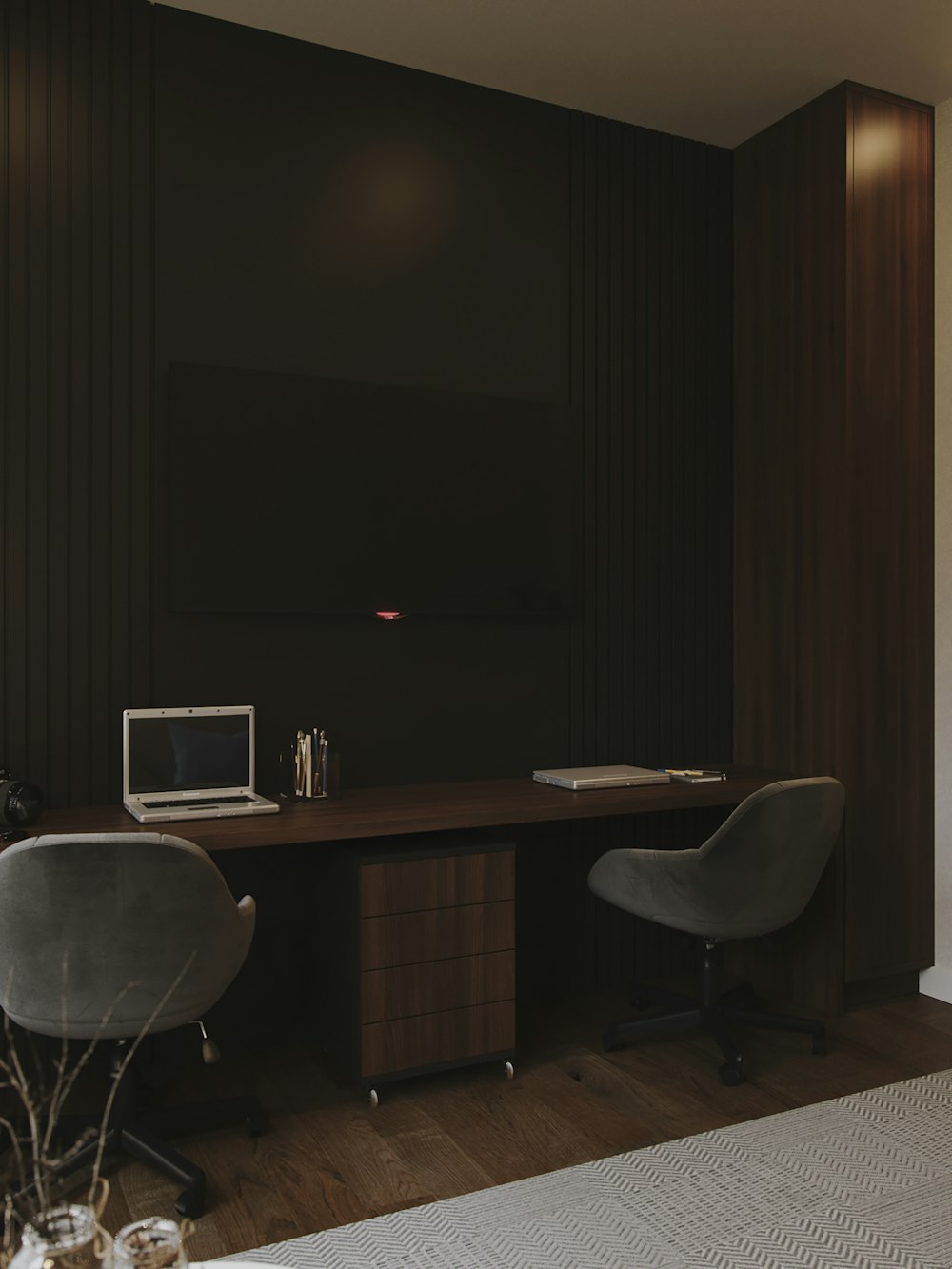 a desk with a chair and a television in the background