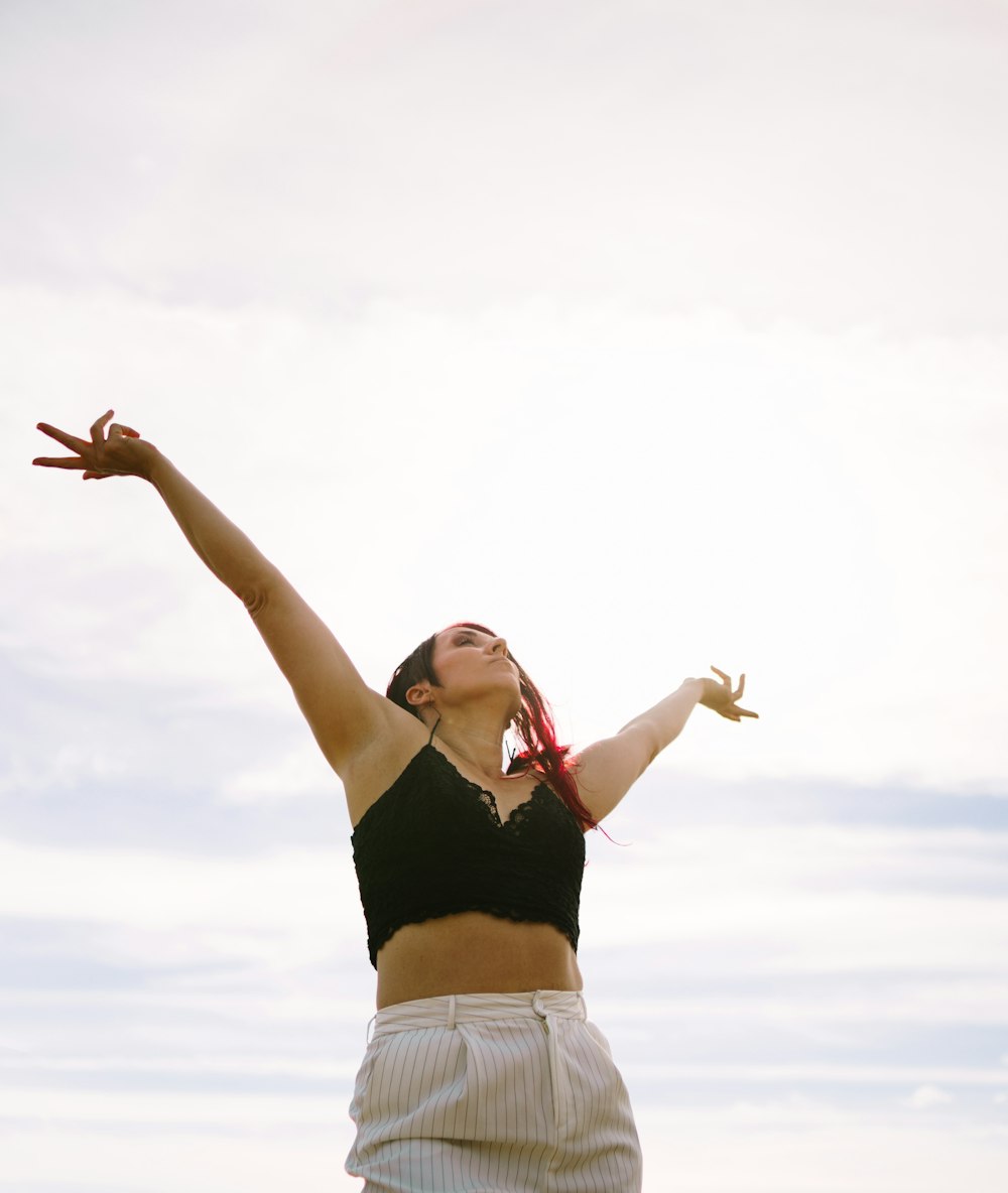 a woman with her arms raised