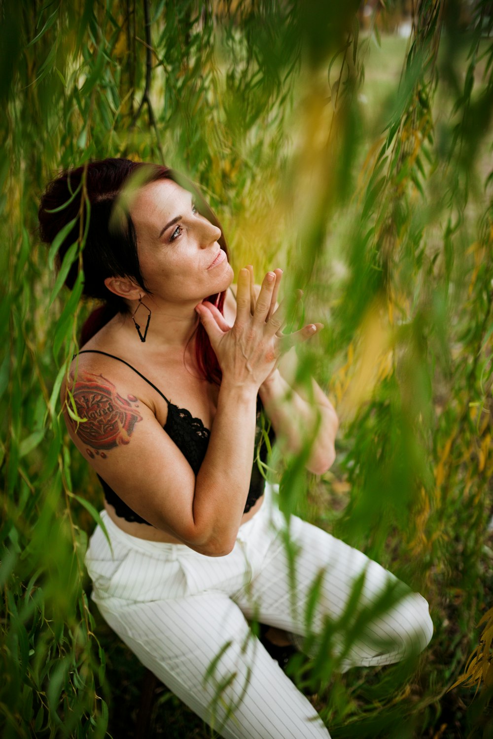 a woman sitting in a grassy area