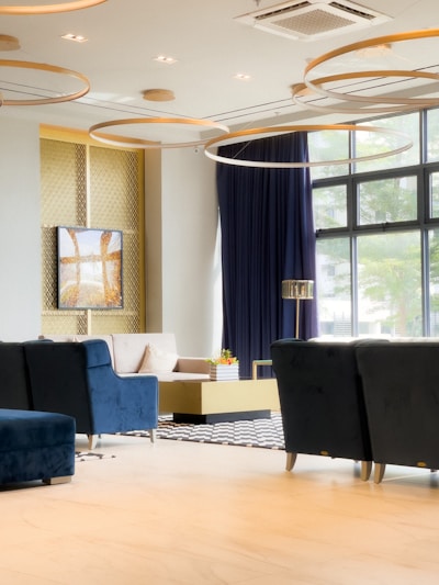 Photo of a modern, sophisticated living room with navy blue and gold accents.