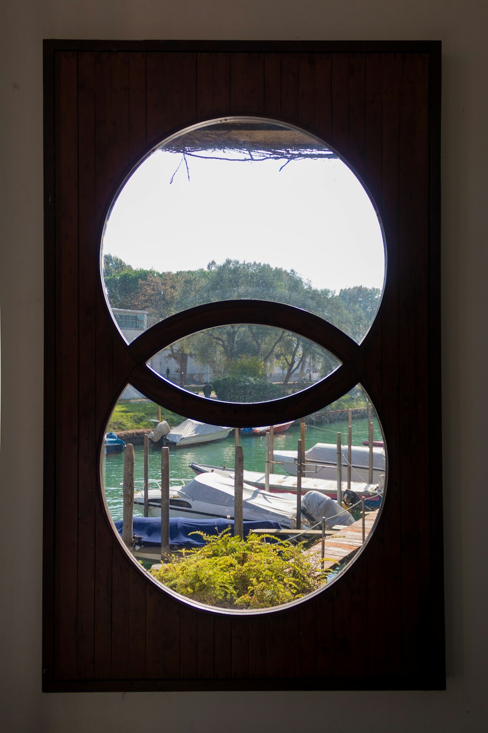 a window with a view of a park and trees