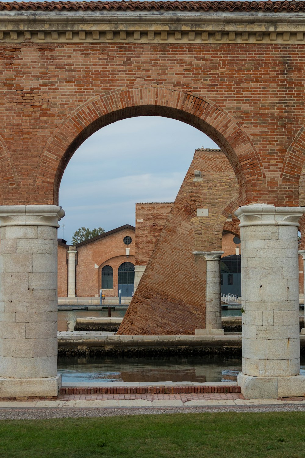 a brick archway over a pond