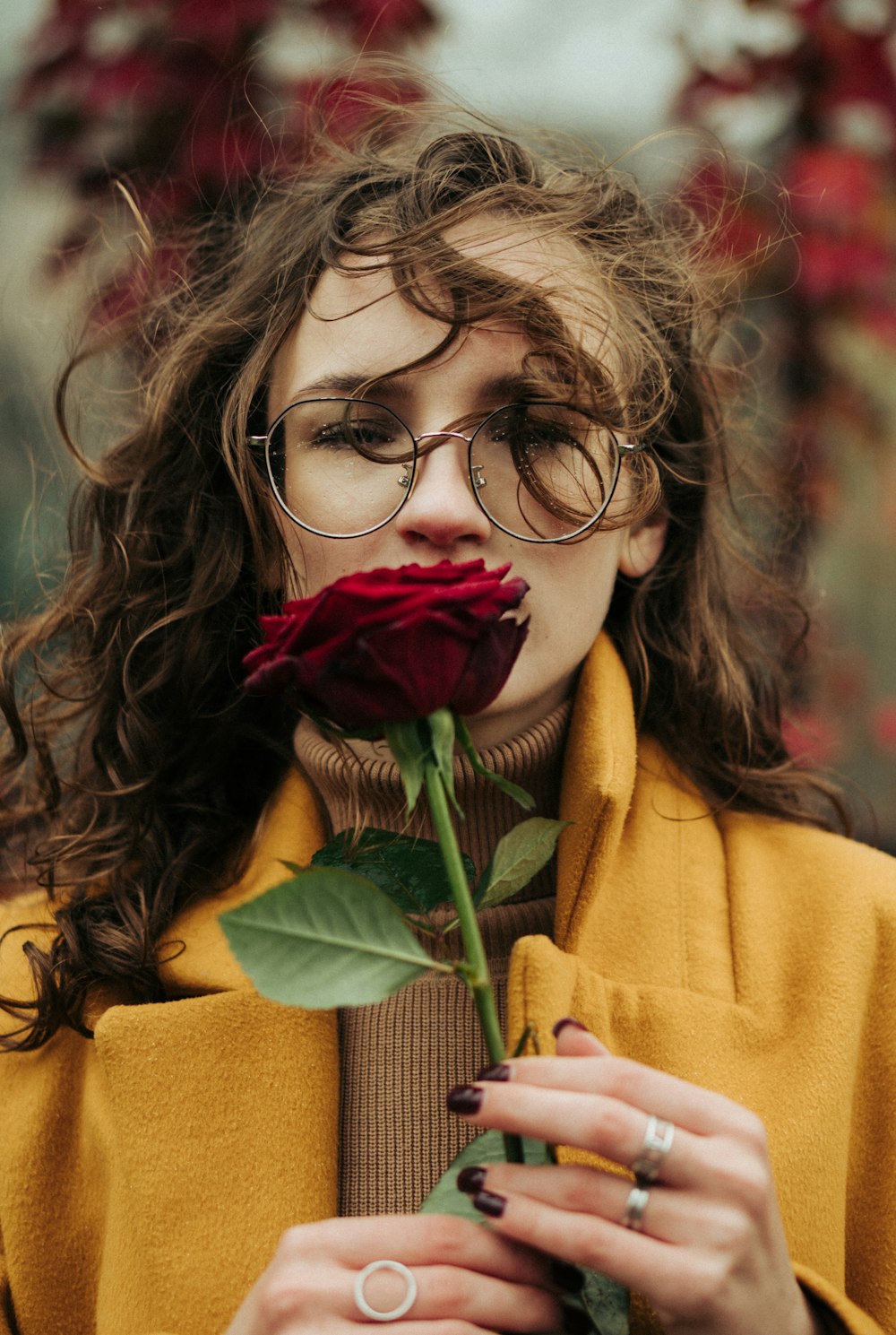 a woman smelling a rose