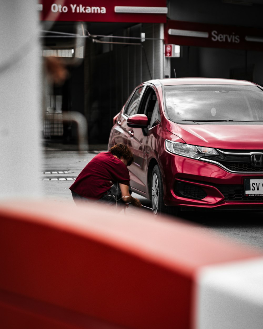 a person leaning on a car