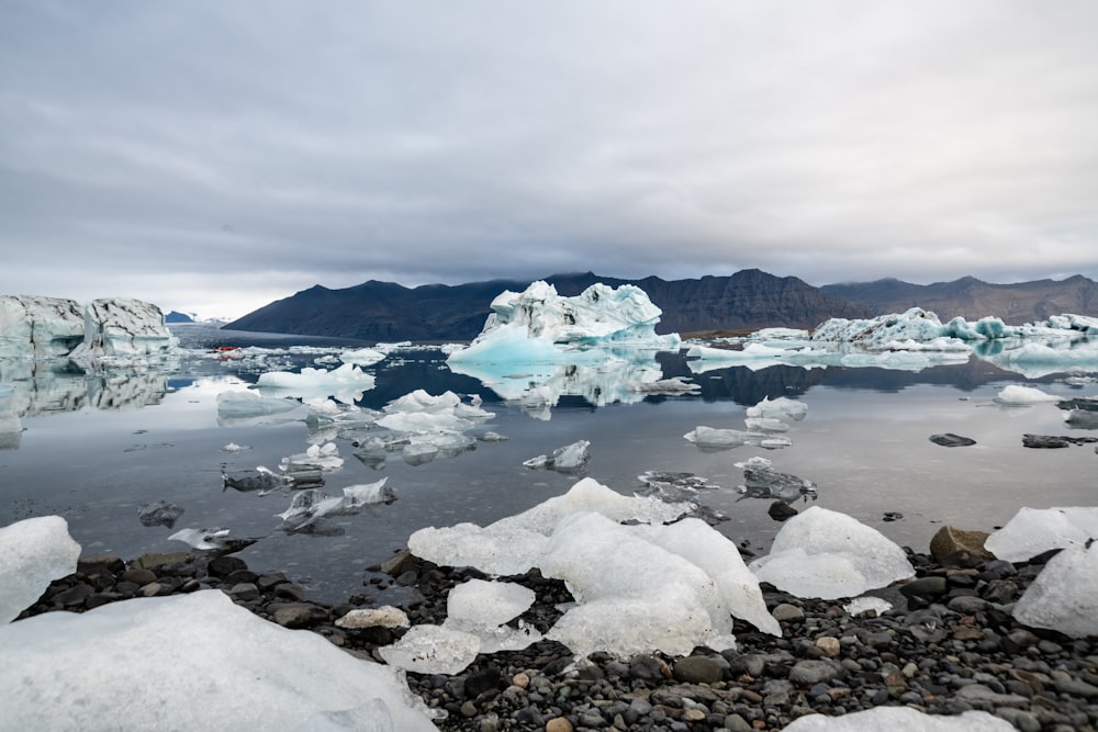 a snowy landscape with ice and water