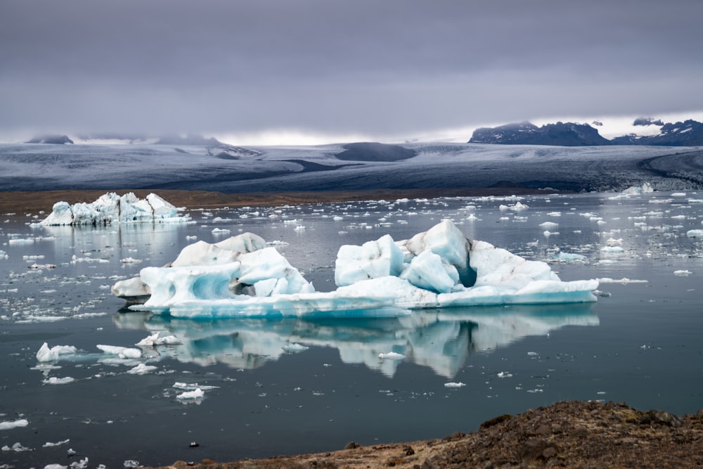 a body of water with ice and snow on it