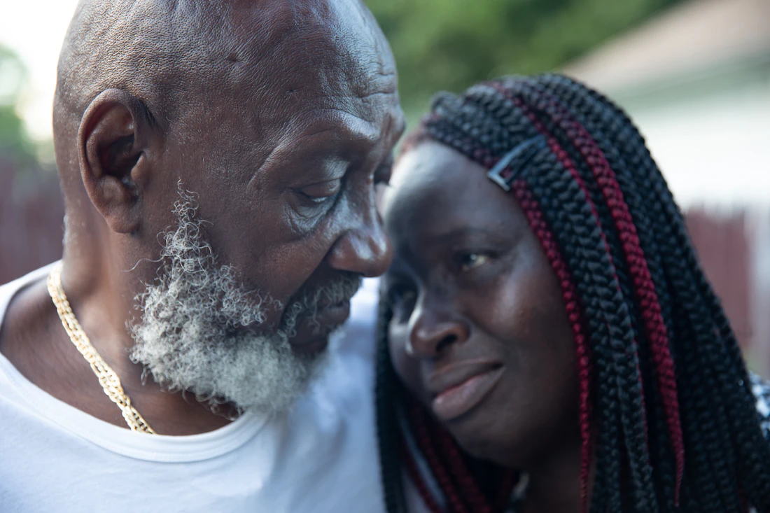 Older man and woman sitting together at home