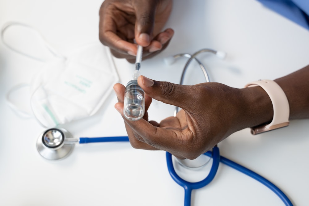 a person holding a stethoscope over a person's hand