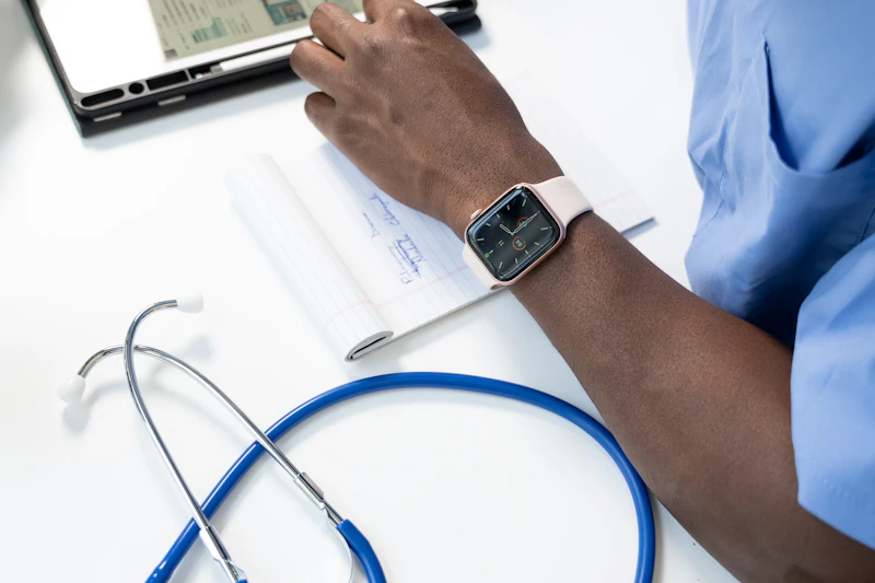 Healthcare worker reviewing clinical records with tablet and stethoscope
