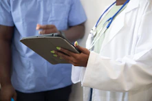 a doctor showing a patient something on the tablet