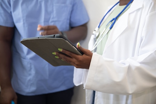 a doctor showing a patient something on the tablet