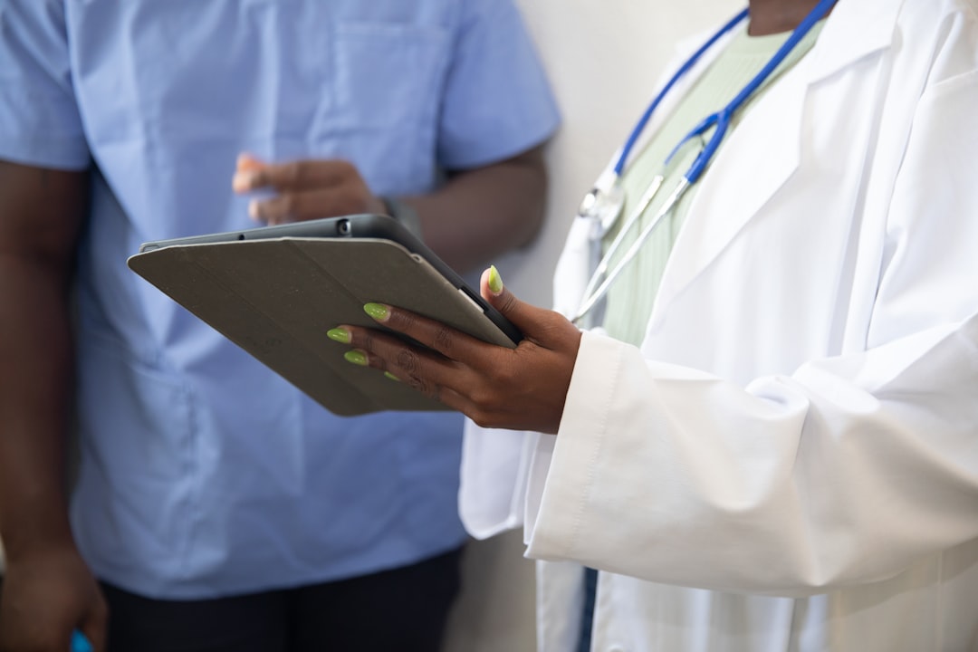 a doctor showing a patient something on the tablet,