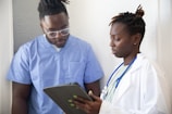 a doctor showing a patient something on the tablet