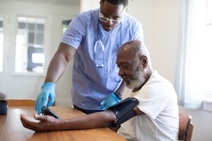 a man showing a man something on the tablet
