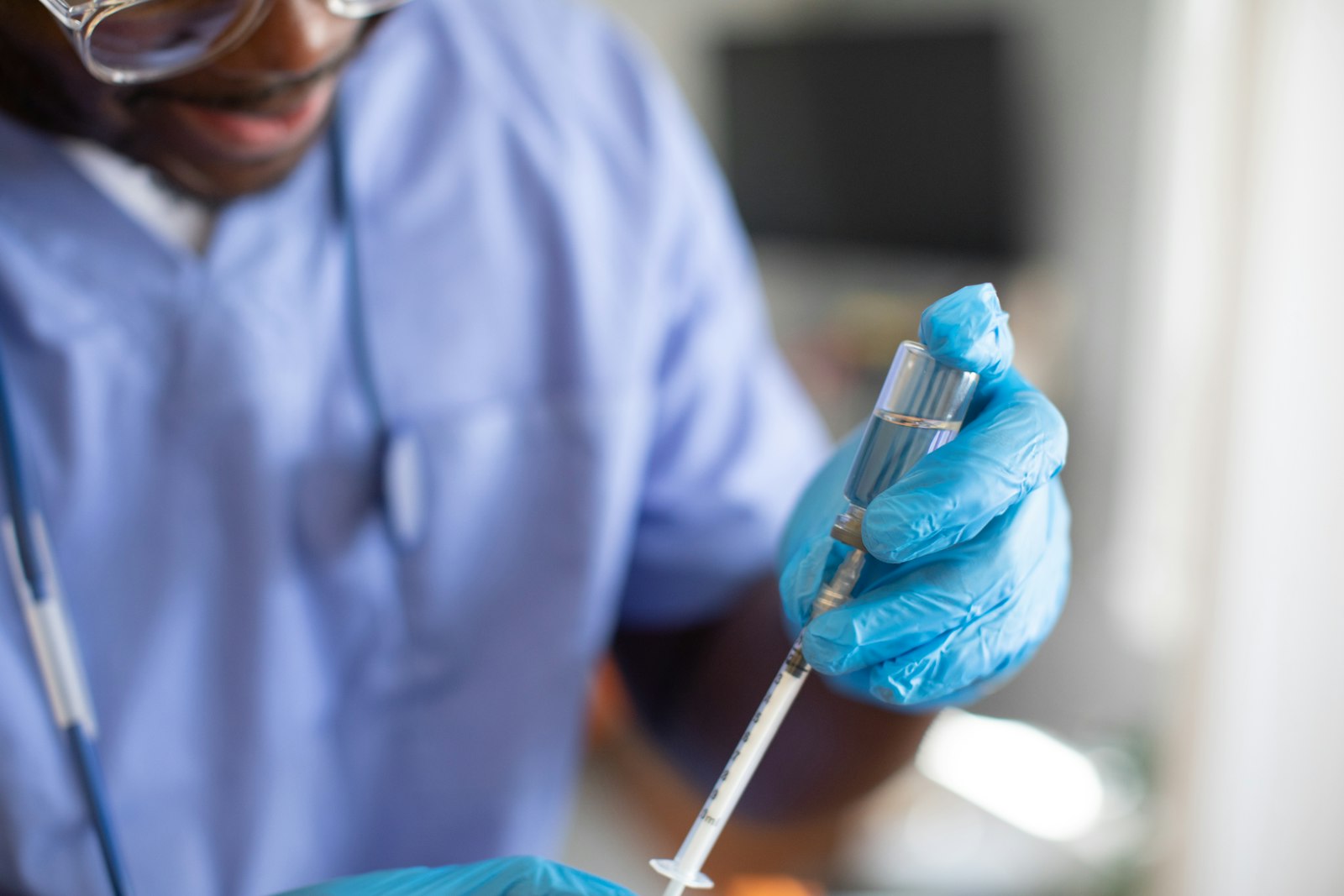 A gloved hand holding a syringe, representing the manufacturing and monitoring questions that determine a peptide's real risk