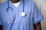 a person wearing a blue shirt with a white circle on it