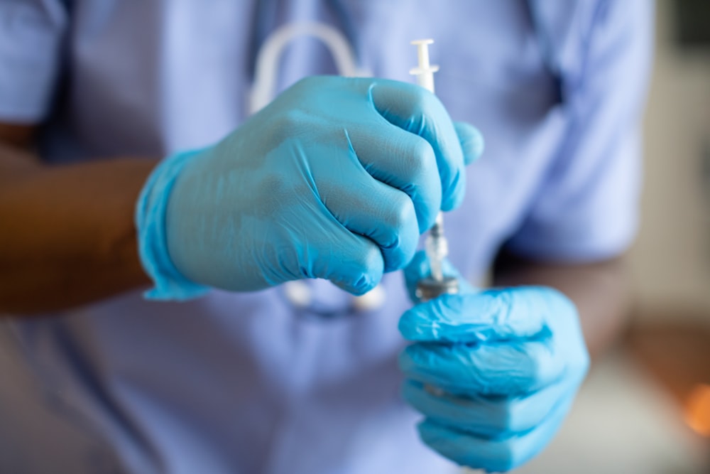 a person holding a syringe