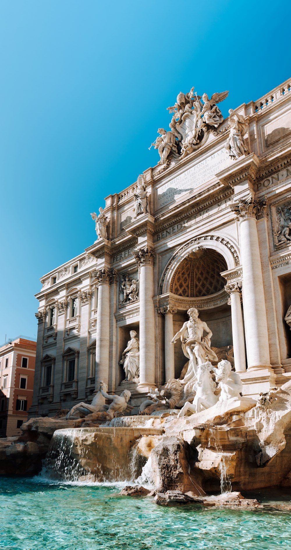 a fountain with statues and Trevi Fountain