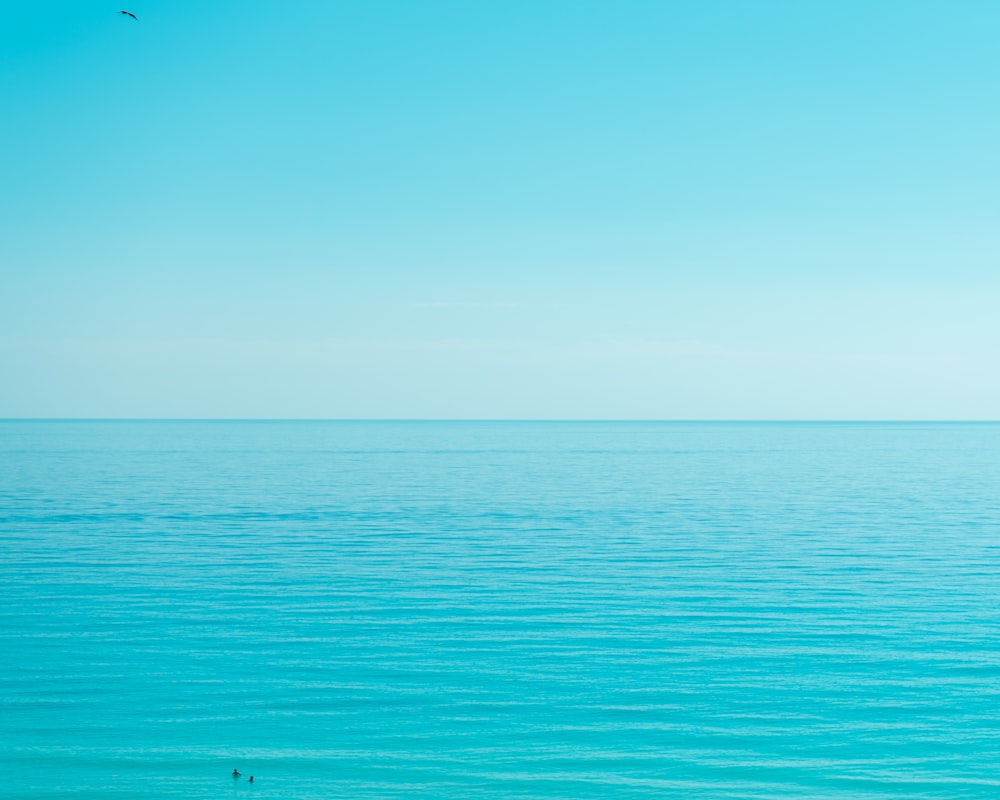 a body of water with a blue sky above