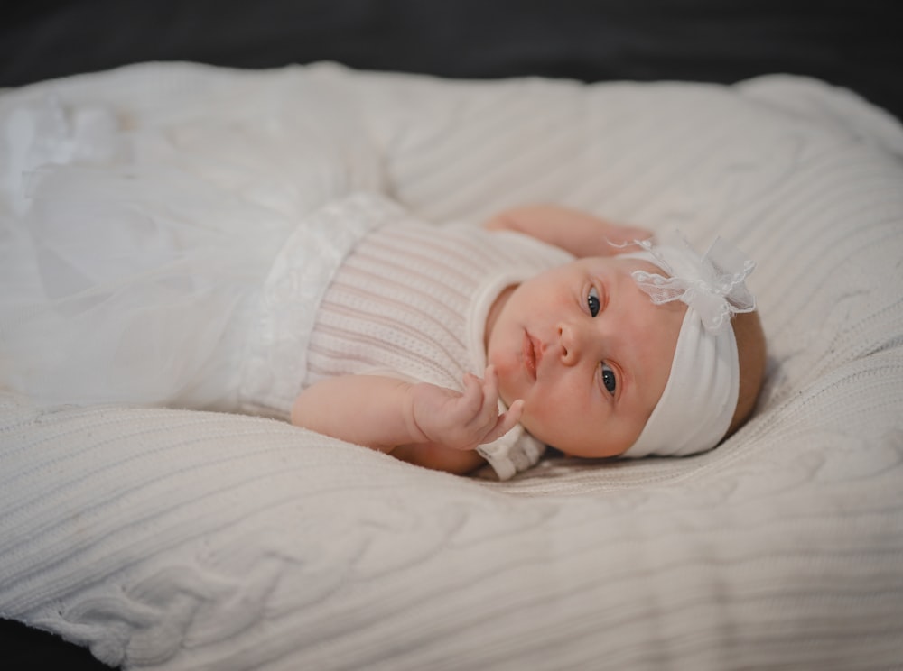 a baby lying on a bed