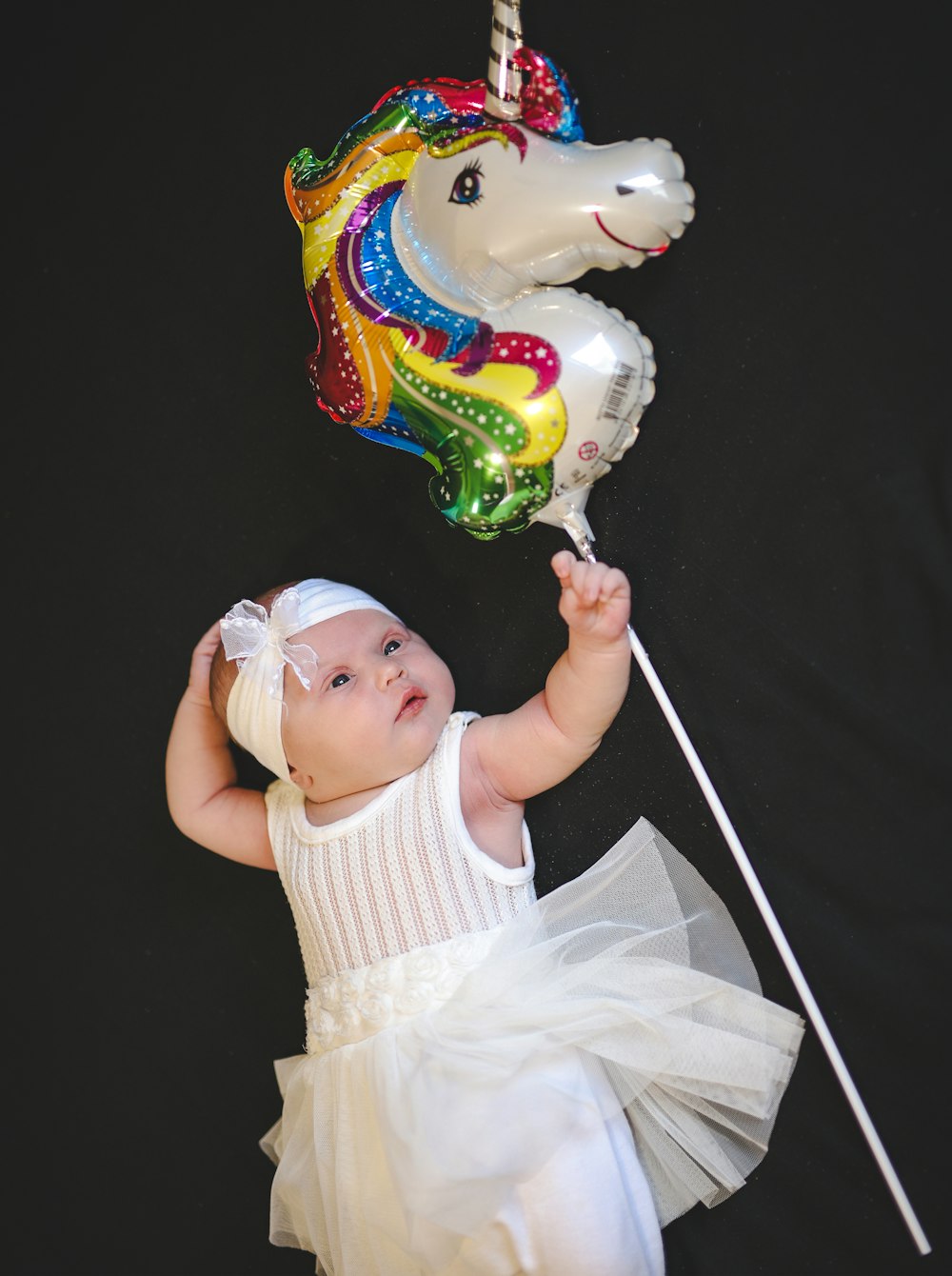 a baby holding a balloon