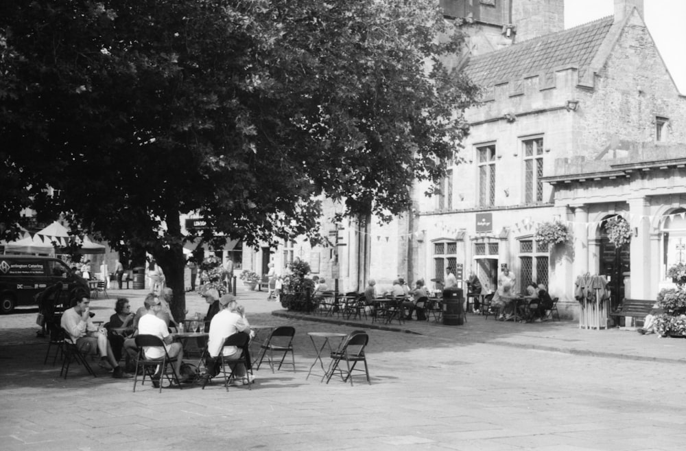 people sitting at tables outside