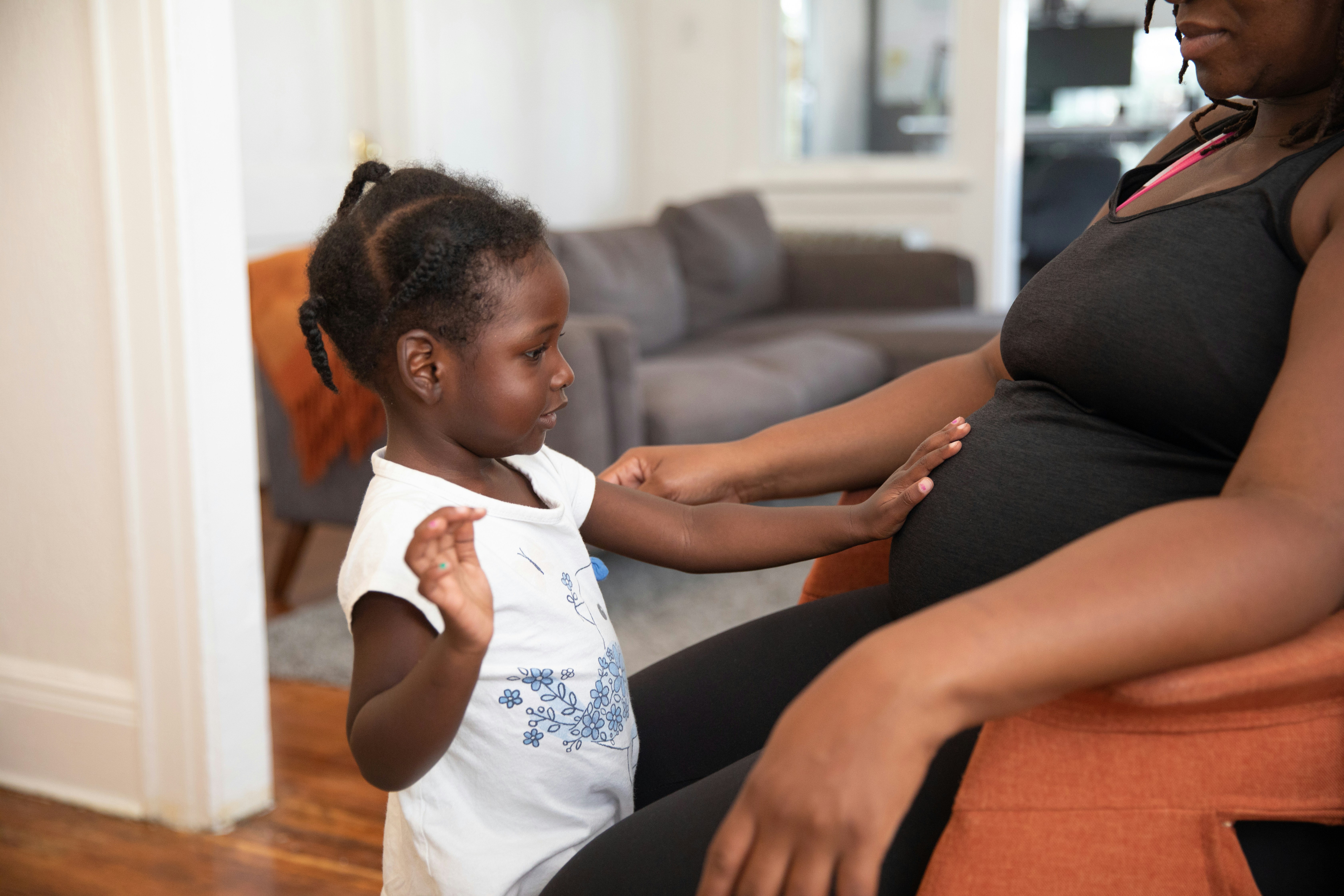 a person and a child sitting on a couch