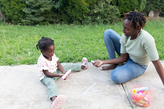 a person and a child playing with sand