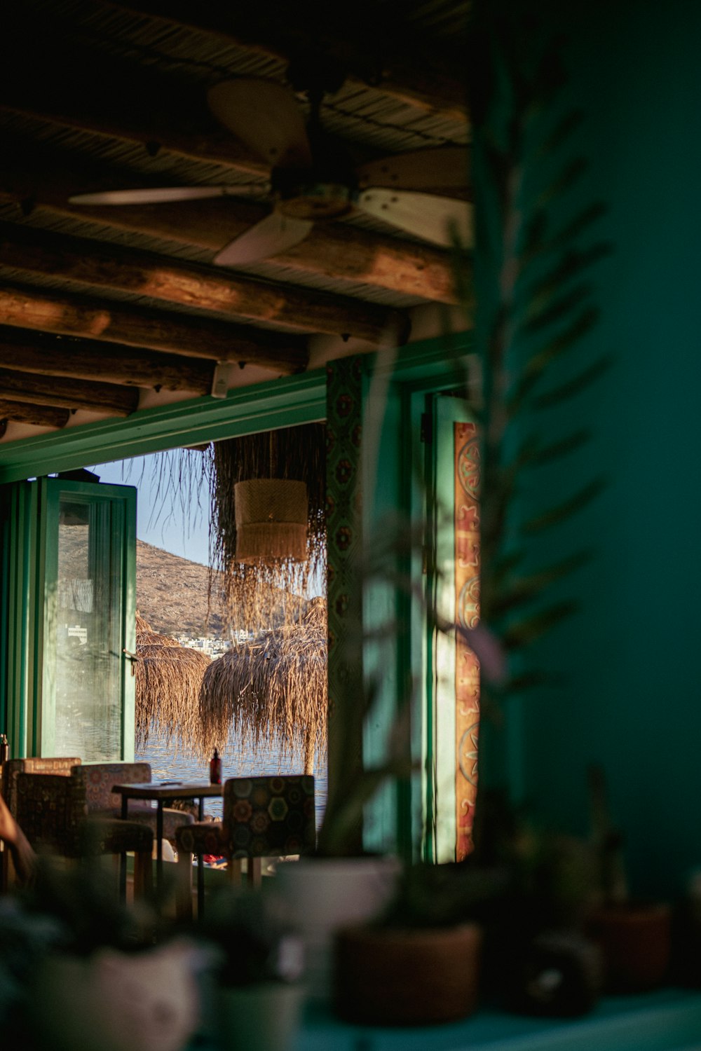 a room with a green wall and a wood ceiling