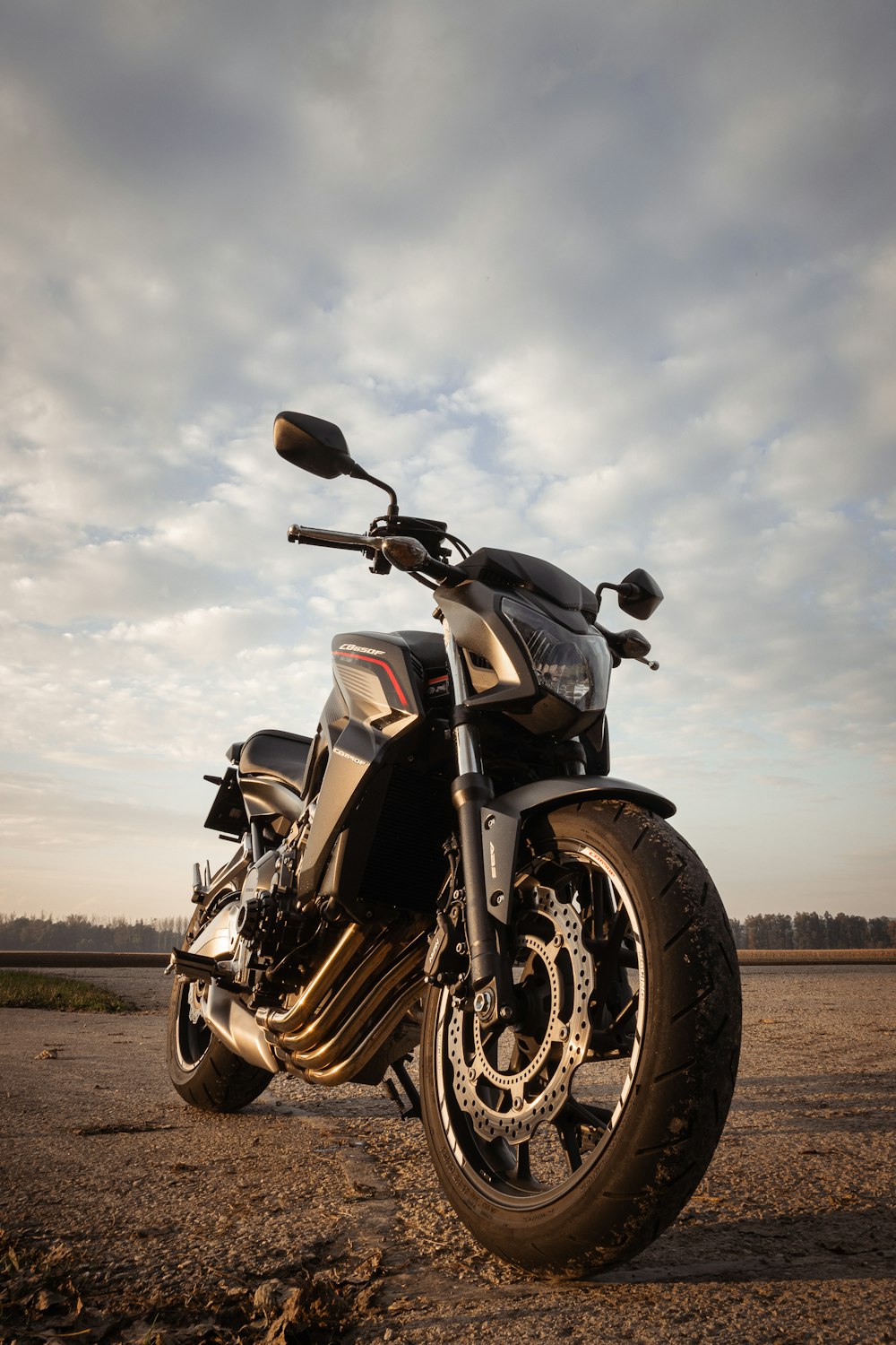 a motorcycle parked on a dirt road