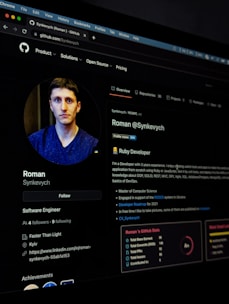 A digital profile screen viewed on a web browser, showcasing a user's account on a platform. The profile includes a photo of a person, details about their job as a Software Engineer, and professional achievements. There is also a description of their developer skills and project experiences. The GitHub interface shows navigation tabs along the top and profile details in the main content area.