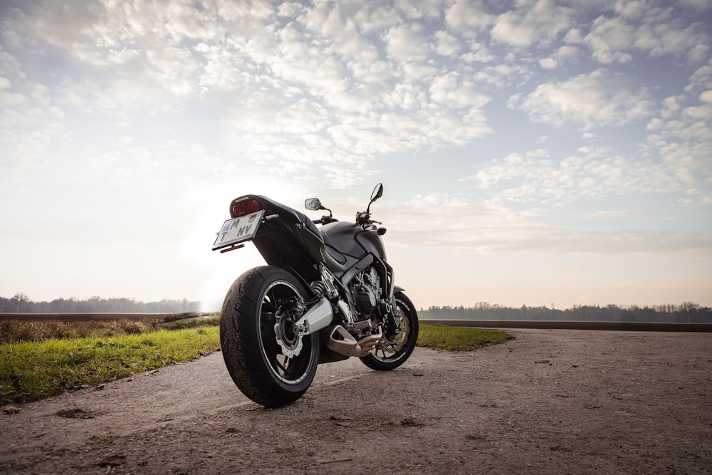 a motorcycle parked on a dirt road