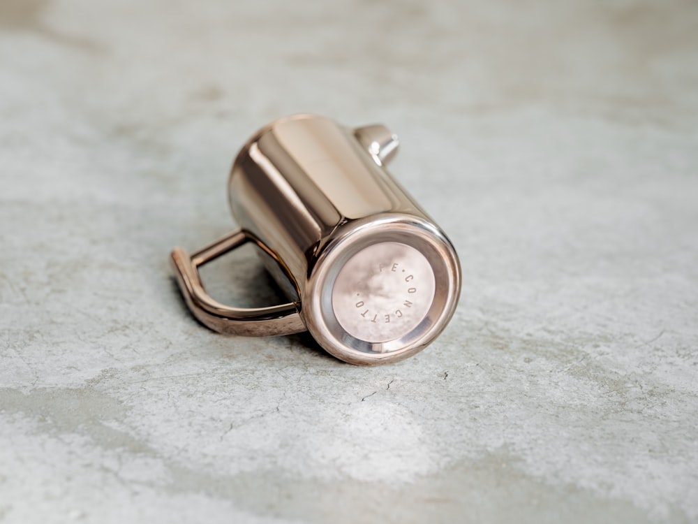 a silver watch on a white surface