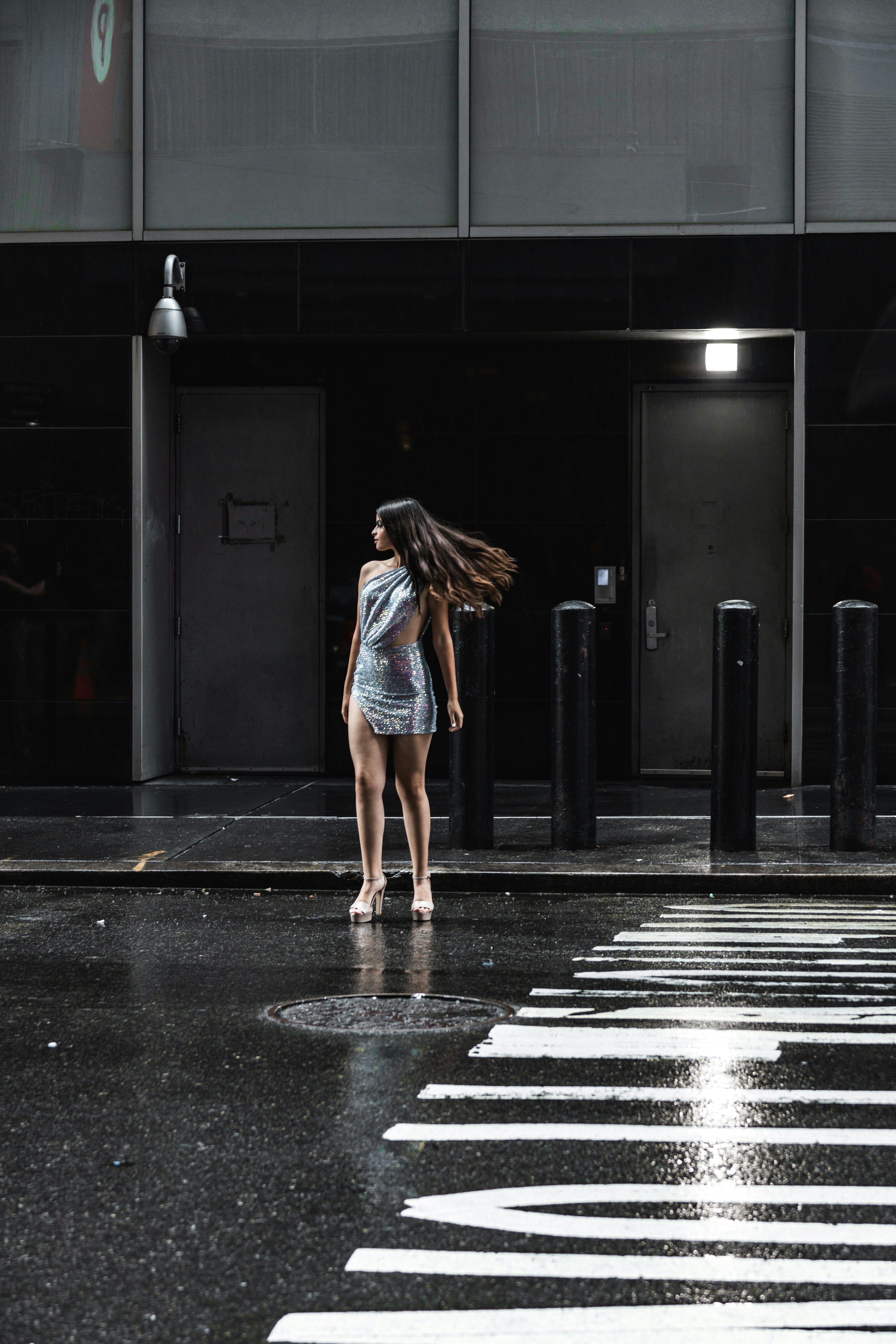 A person standing in front of a building photo – Free Fashion Image on ...