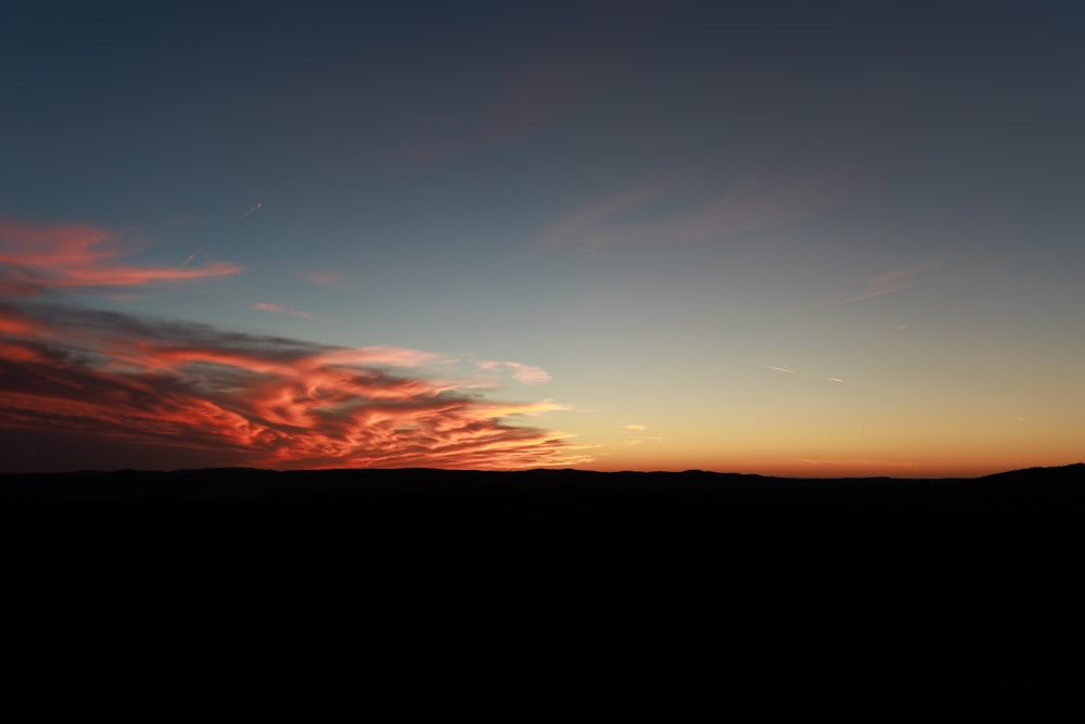 a sunset over a mountain