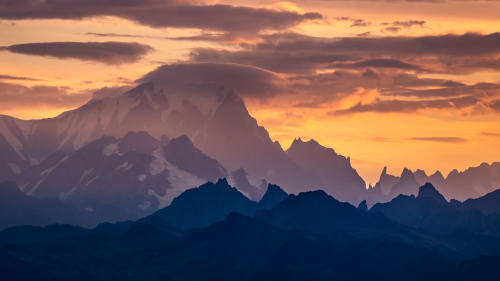 a mountain range with clouds