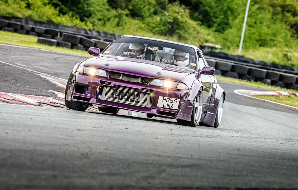 a purple race car on a road